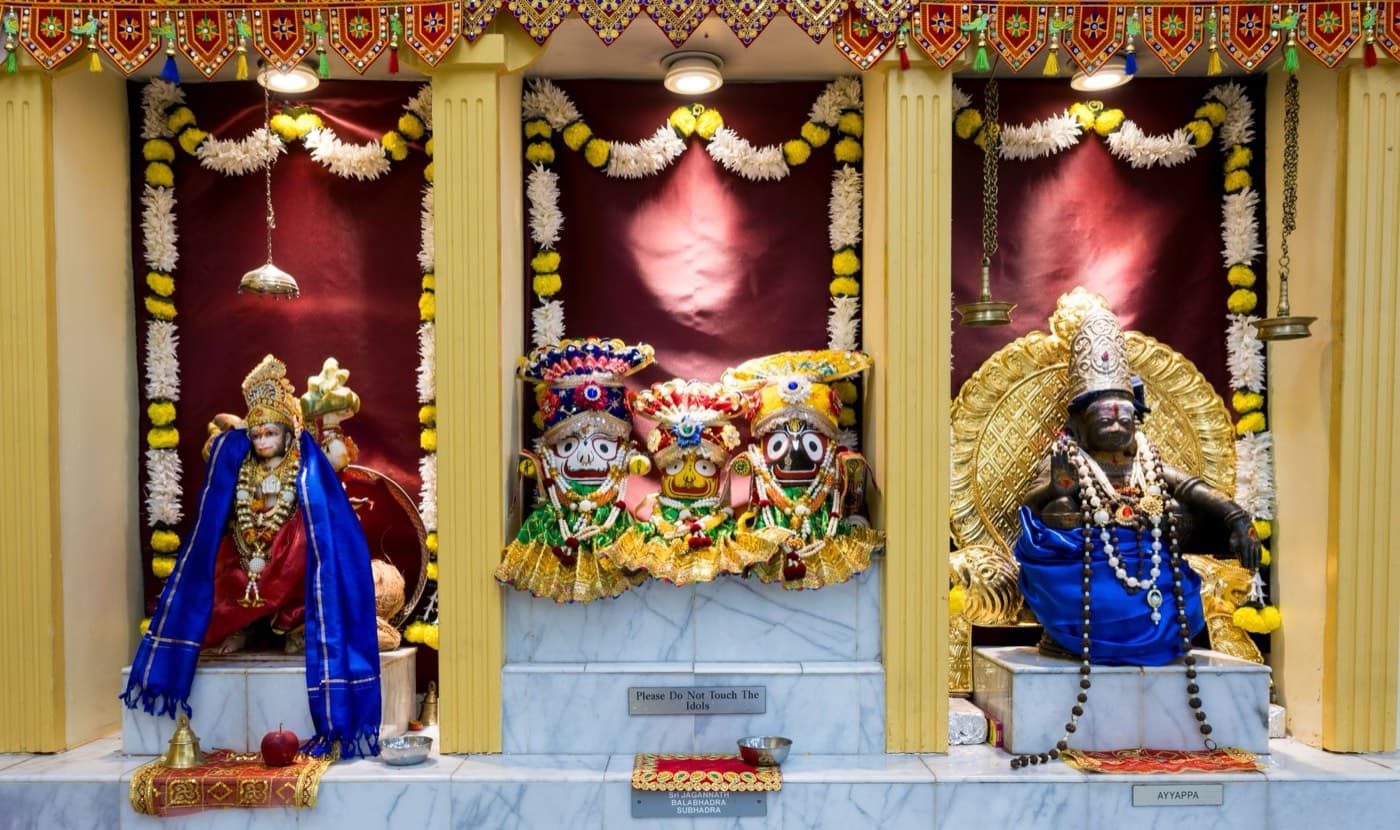 Three shrines side by side at HTCC Kansas City: Hanuman, Lord Jagannath with Balabhadra and Subhadra, and Ayyappa Swami