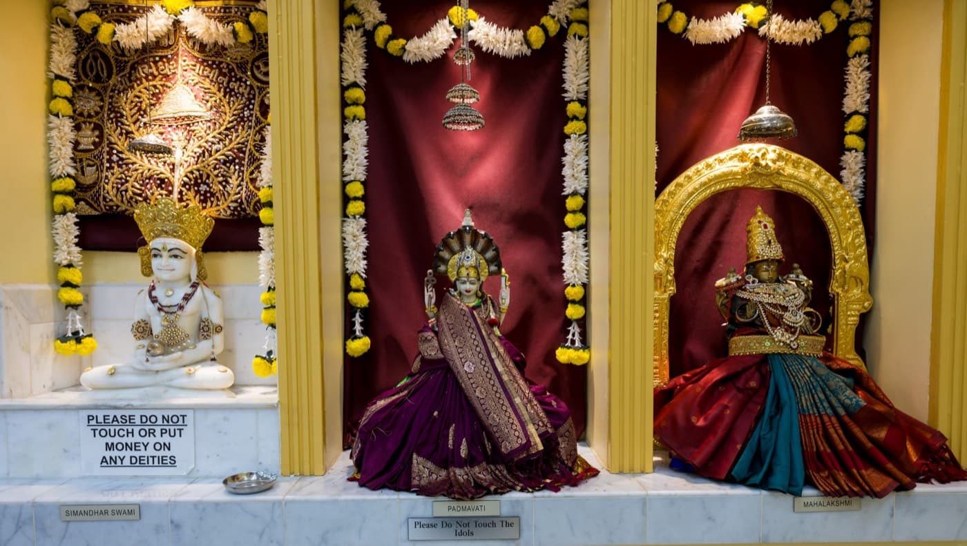 The Jain and Devi shrines at HTCC Kansas City: Simandhar Swami in white marble, Padmavati Devi, and Mahalakshmi in a gold arch