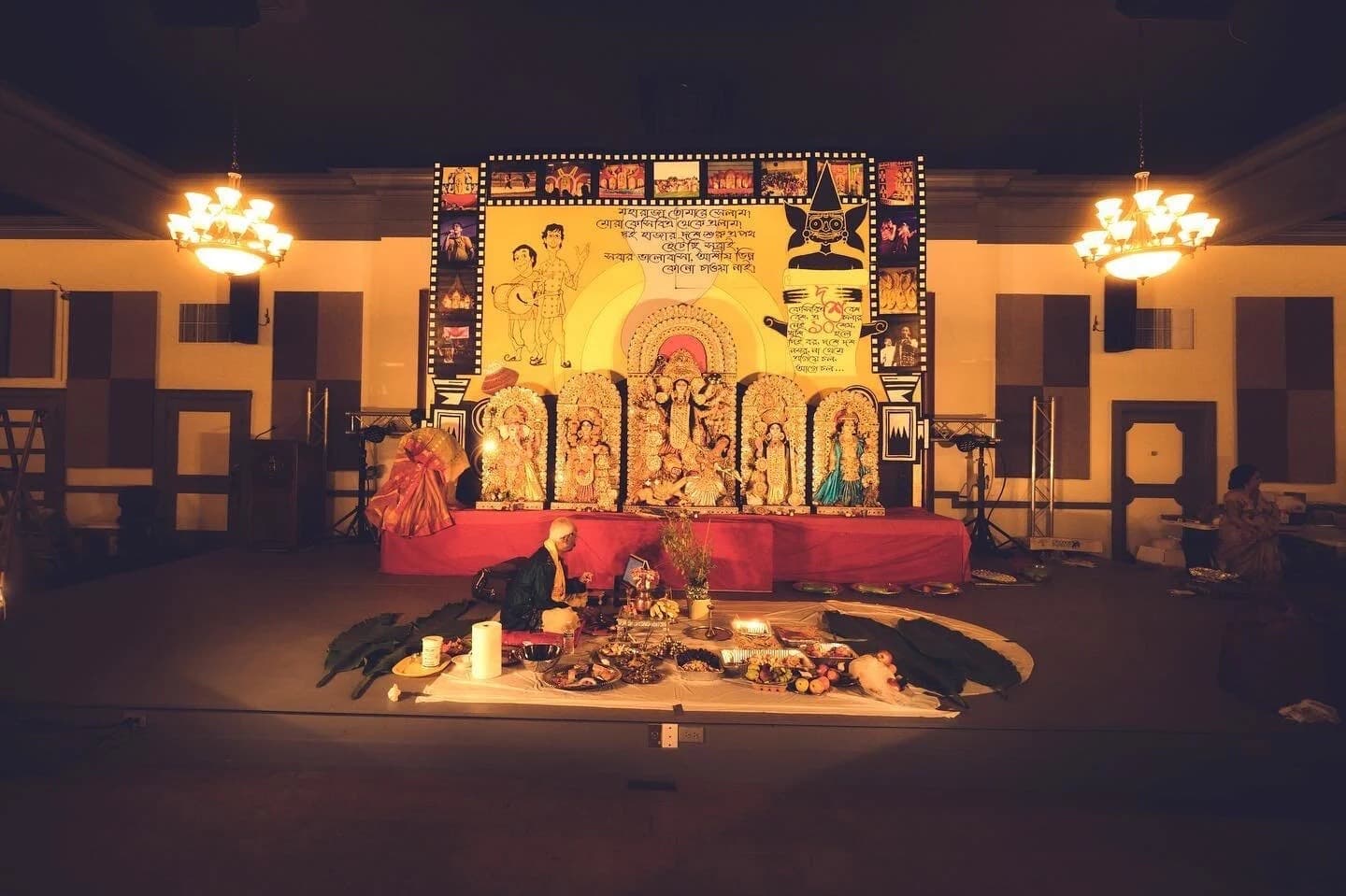 The Durga Puja 2022 stage at the Kansas City Scottish Rite — Ma Durga flanked by Ganesh, Lakshmi, Saraswati and Kartik, under a Gupi–Bagha backdrop for KCBA's tenth-year celebration
