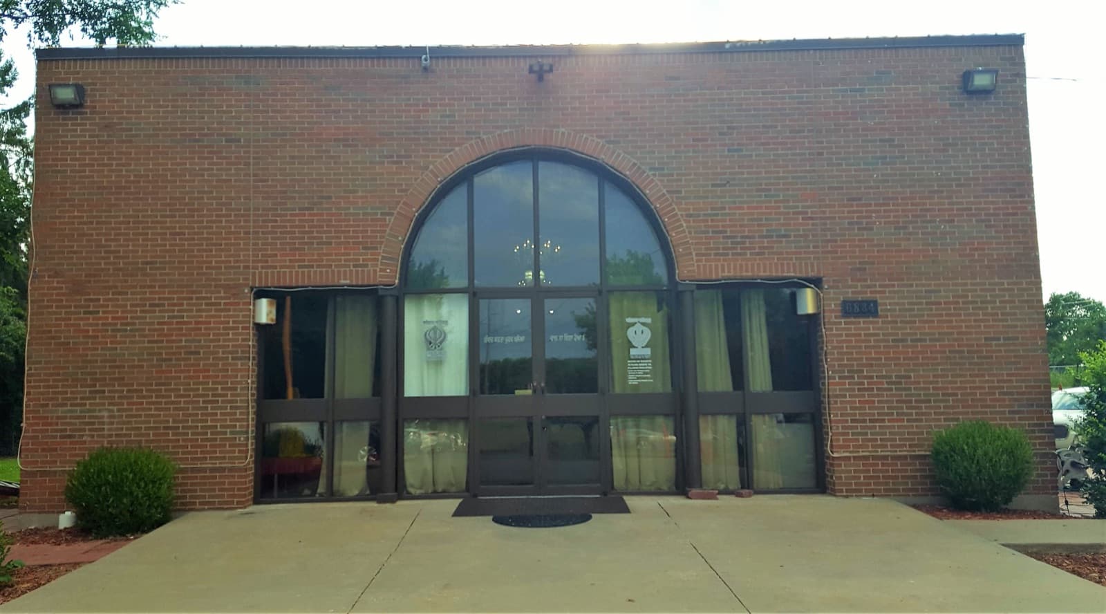 The brick front of the Midwest Sikh Gurudwara on Pflumm Road in Shawnee, the sangat's home from 1989 to 2022, photographed in July 2018